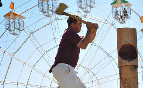 Lindsay Hewitt competes in the wood chop events at the Gympie Show last Friday. Setting the carnival atmosphere in the background is the big wheel. Lindsay Hewitt competes in the wood chop events at the Gympie Show last Friday. Setting the carnival atmosphere in the background is the big wheel.